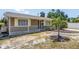 Charming single-story home with neutral siding, white picket fence, and a well-manicured lawn at 2719 Boca Ciega N Dr, St Petersburg, FL 33710