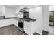 Kitchen view highlighting stainless steel gas range, dark countertops and white cabinetry at 2719 Boca Ciega N Dr, St Petersburg, FL 33710