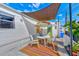 Inviting back patio with a colorful outdoor rug, seating, and a shade sail for relaxation at 27466 Us Highway 19 N # 56, Clearwater, FL 33761