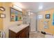 Bathroom featuring a shower with glass doors and a wooden vanity with granite top at 27466 Us Highway 19 N # 56, Clearwater, FL 33761