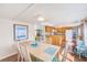Open-concept dining area connecting to a modern kitchen with ample lighting at 27466 Us Highway 19 N # 56, Clearwater, FL 33761