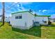 Exterior view of home showcasing white siding and a green trim at 27466 Us Highway 19 N # 56, Clearwater, FL 33761