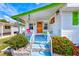 Inviting front porch with a bright orange door and colorful landscaping at 27466 Us Highway 19 N # 56, Clearwater, FL 33761