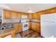 Efficient kitchen features white appliances, wood cabinets, laminate countertops, and modern hardware at 27466 Us Highway 19 N # 56, Clearwater, FL 33761