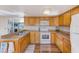 A well-maintained kitchen with wood cabinets, modern appliances, and ample counter space at 27466 Us Highway 19 N # 56, Clearwater, FL 33761