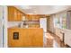 Cozy kitchen features wood cabinets, laminate countertops and flooring, plus white appliances and ample natural light at 27466 Us Highway 19 N # 56, Clearwater, FL 33761