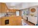 Charming kitchen with wooden cabinets, laminate countertops, stainless trash can, and updated flooring at 27466 Us Highway 19 N # 56, Clearwater, FL 33761