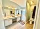 Spacious bathroom featuring a double sink vanity and glass enclosed shower at 2776 Golf Lake Dr # 1, Plant City, FL 33566