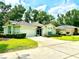 Charming single-story home showcasing lush landscaping, a two-car garage, and a welcoming tiled roof at 2776 Golf Lake Dr # 1, Plant City, FL 33566