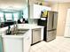 Open kitchen featuring stainless steel appliances, a breakfast bar, and ample counter space at 2776 Golf Lake Dr # 1, Plant City, FL 33566