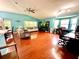 Spacious living room with wood floors, vaulted ceilings, and bright natural light from large windows at 2776 Golf Lake Dr # 1, Plant City, FL 33566