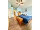 Bright main bedroom featuring wood floors and a comfortable bed at 2776 Golf Lake Dr # 1, Plant City, FL 33566