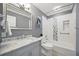 Updated bathroom features a modern vanity, framed mirror, and tiled shower at 301 62Nd S Ave, St Petersburg, FL 33705