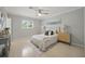 Cozy bedroom featuring a queen bed, coastal-themed decor, and soft natural light filtering through the window at 301 62Nd S Ave, St Petersburg, FL 33705