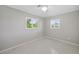 Cozy bedroom with terrazzo flooring is well lit by two windows at 301 62Nd S Ave, St Petersburg, FL 33705
