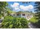 Single story home surrounded by beautiful landscaping with stone pathway at 301 62Nd S Ave, St Petersburg, FL 33705
