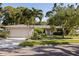 Charming single-story home boasts lush landscaping, a well-maintained lawn, and a two-car garage at 301 62Nd S Ave, St Petersburg, FL 33705