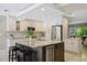 Bright kitchen featuring granite counters, stainless steel appliances and large center island with seating and wine chiller at 301 62Nd S Ave, St Petersburg, FL 33705