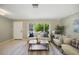 Cozy living room featuring neutral decor, large windows, and comfortable seating at 301 62Nd S Ave, St Petersburg, FL 33705
