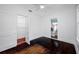 Bright bedroom with hardwood floors and white walls, with view to laundry room at 3100 11Th N Ave, St Petersburg, FL 33713