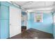 View of room with blue walls, with view to laundry room at 3100 11Th N Ave, St Petersburg, FL 33713