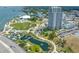 Expansive aerial view showcasing the high-rise location adjacent to a park with water features and winding paths at 331 Cleveland St # 1202, Clearwater, FL 33755
