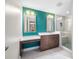 Modern bathroom with dual vanity, walk-in shower with teal accent wall at 331 Cleveland St # 1202, Clearwater, FL 33755