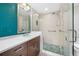 Bright bathroom featuring a sleek vanity and a glass-enclosed shower with mosaic tile floor at 331 Cleveland St # 1202, Clearwater, FL 33755
