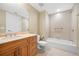 This well-lit bathroom features a vanity, toilet, and shower-tub combination with tiled walls at 331 Cleveland St # 1202, Clearwater, FL 33755