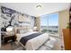 Bright bedroom featuring a floral accent wall, large window with a city view, and stylish furnishings at 331 Cleveland St # 1202, Clearwater, FL 33755