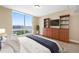 Inviting bedroom boasts a large window overlooking the water and custom built-in media center at 331 Cleveland St # 1202, Clearwater, FL 33755