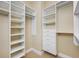 This walk-in closet features custom shelving, drawers, and hanging rods for optimal organization at 331 Cleveland St # 1202, Clearwater, FL 33755
