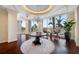 Open seating area featuring decorative lighting and a view of palm trees through expansive windows at 331 Cleveland St # 1202, Clearwater, FL 33755