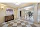 Hallway featuring tiled floors, decorative lighting, and seating area with bright windows at 331 Cleveland St # 1202, Clearwater, FL 33755
