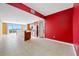 Open floor plan with tile flooring, a view of the city, and a bright red accent wall at 331 Cleveland St # 1202, Clearwater, FL 33755