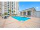 Outdoor pool area with a clear, inviting pool, lounge chairs, and views of the surrounding architecture at 331 Cleveland St # 1202, Clearwater, FL 33755