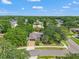 An aerial view showcases the home's location in a lush, established neighborhood with mature trees at 3320 Pattie Pl, Palm Harbor, FL 34685