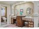 Elegant bathroom with dual sinks, decorative mirrors, and a separate toilet room at 3320 Pattie Pl, Palm Harbor, FL 34685