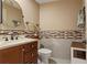 Neutral powder room boasts a vessel sink, marble countertop, and decorative mosaic tile at 3320 Pattie Pl, Palm Harbor, FL 34685
