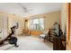 Inviting bedroom with a Peloton bike, neutral walls, and natural light from the window at 3320 Pattie Pl, Palm Harbor, FL 34685