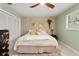 Bright bedroom featuring a ceiling fan, closet, light-colored walls, and a large bed at 3320 Pattie Pl, Palm Harbor, FL 34685
