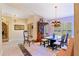 Bright dining room featuring tile flooring, a modern chandelier, and a view of the front entrance at 3320 Pattie Pl, Palm Harbor, FL 34685
