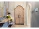 Grand entryway with decorative arch, custom double doors, and accent lighting at 3320 Pattie Pl, Palm Harbor, FL 34685