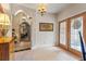 Welcoming foyer with decorative tile, arched doorways, and natural light streaming through ornate glass doors at 3320 Pattie Pl, Palm Harbor, FL 34685