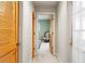 Bright hallway leading to a sunlit room with a comfortable chair and blue rug at 3320 Pattie Pl, Palm Harbor, FL 34685