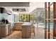 Bright kitchen opens to patio, featuring stainless steel appliances and pool views, perfect for outdoor entertaining at 3320 Pattie Pl, Palm Harbor, FL 34685