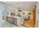 Spacious kitchen island with quartz countertop that connects with an adjacent living room for seamless entertainment at 3320 Pattie Pl, Palm Harbor, FL 34685