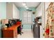 Efficient laundry room featuring built in cabinets, modern appliances, and a cheerful wall color at 3320 Pattie Pl, Palm Harbor, FL 34685