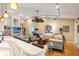 Bright and airy living room featuring hardwood floors, comfortable seating, and modern lighting fixtures at 3320 Pattie Pl, Palm Harbor, FL 34685