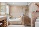 Well-lit bathroom with decorative tub and shower area, plus custom tiled flooring at 3320 Pattie Pl, Palm Harbor, FL 34685